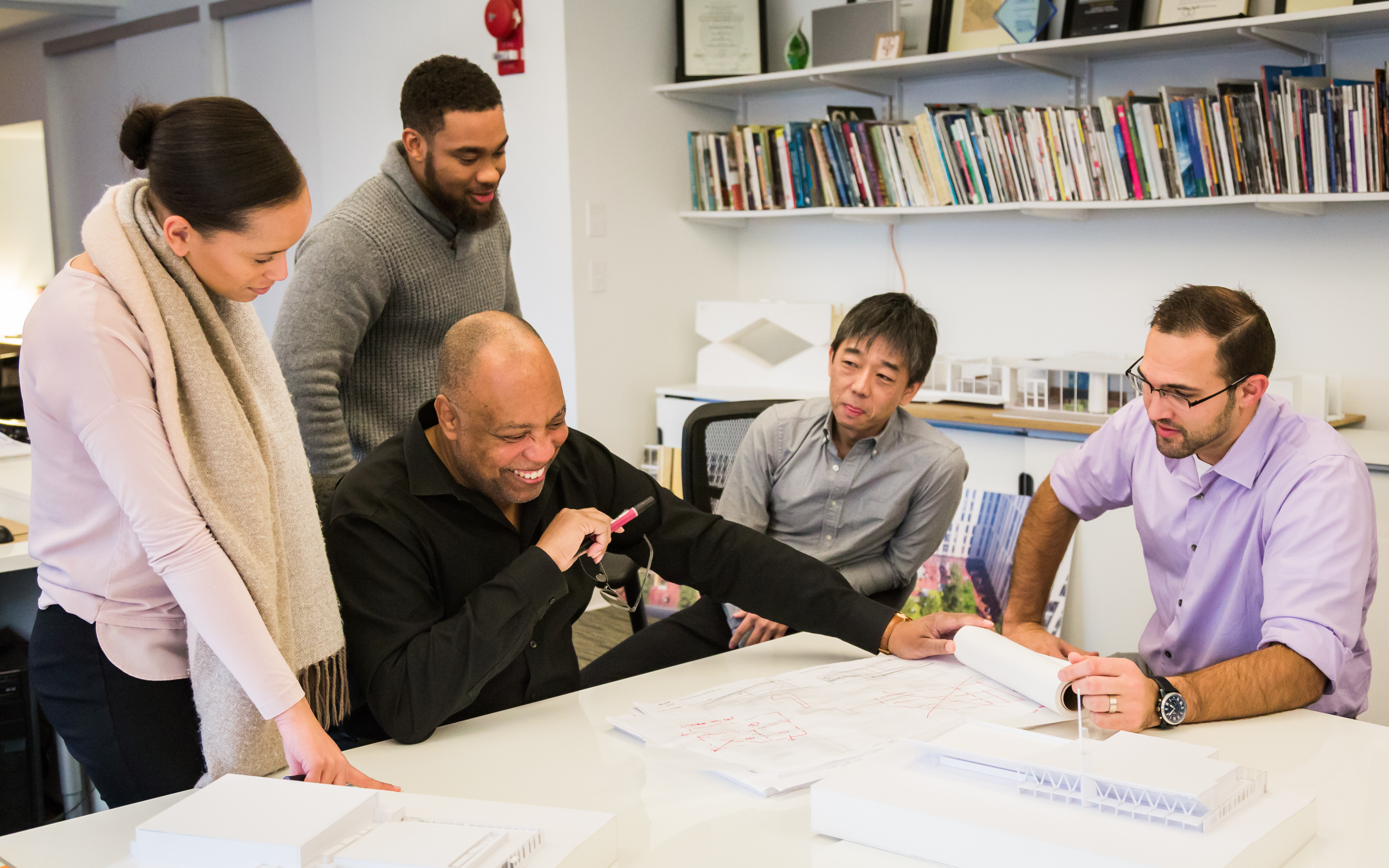 Michael Marshall works with colleagues at a desk at his office.